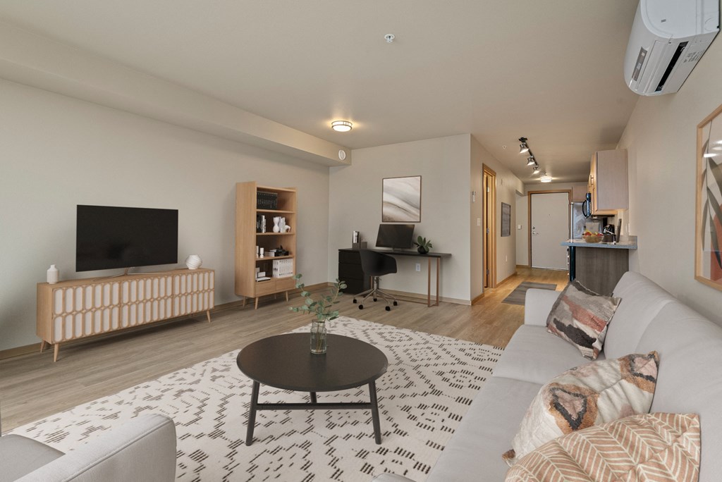 A living room with a television, a couch, and a coffee table.