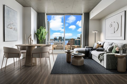 a living room with a couch and a view of the city from a window