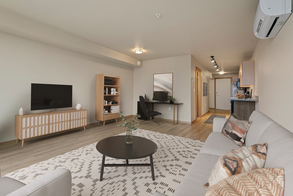 A living room with a television, a couch, and a coffee table.