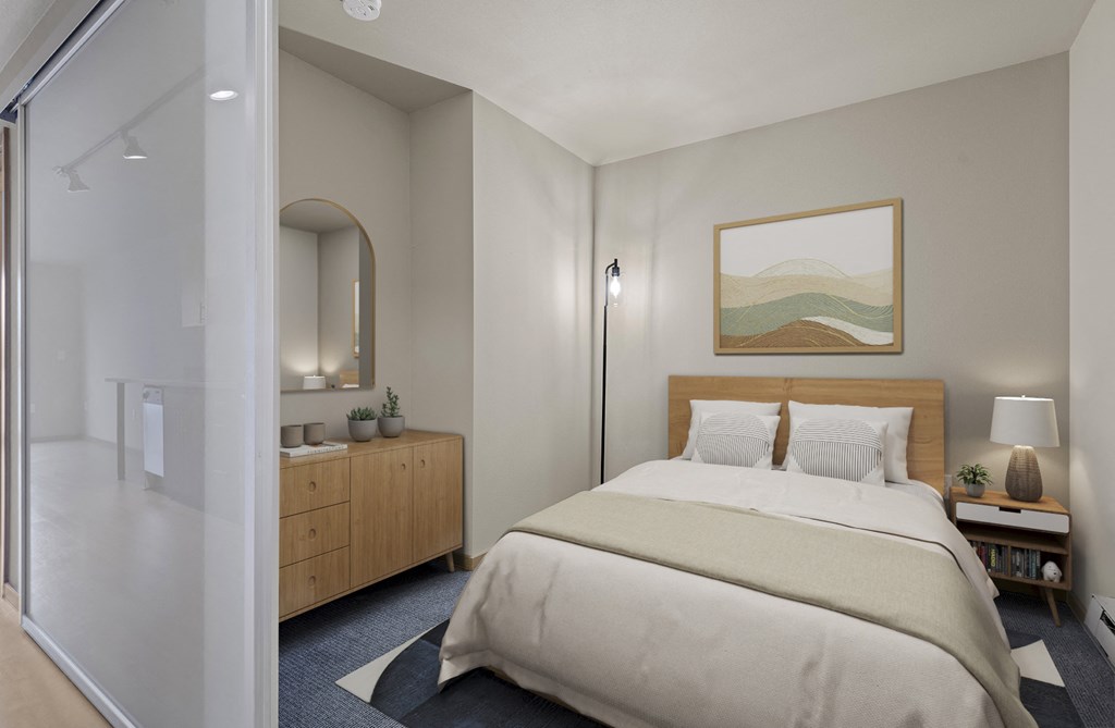 A bedroom with a large bed and a painting on the wall.