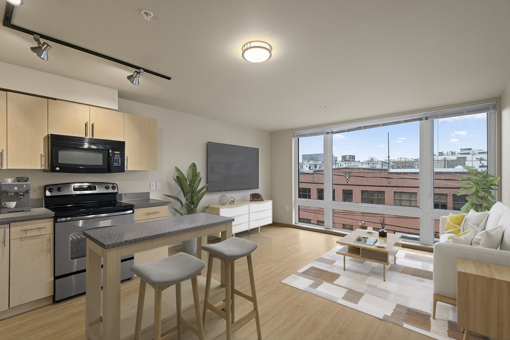 A modern kitchen with a bar stool and a view of the city.