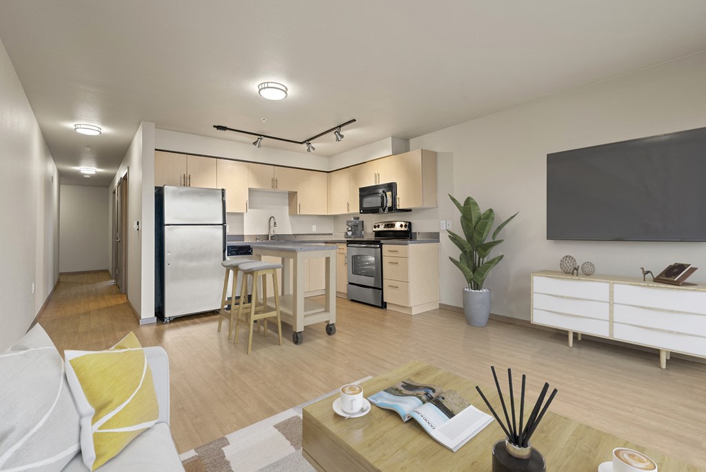 A modern kitchen with a refrigerator, stove, and microwave.