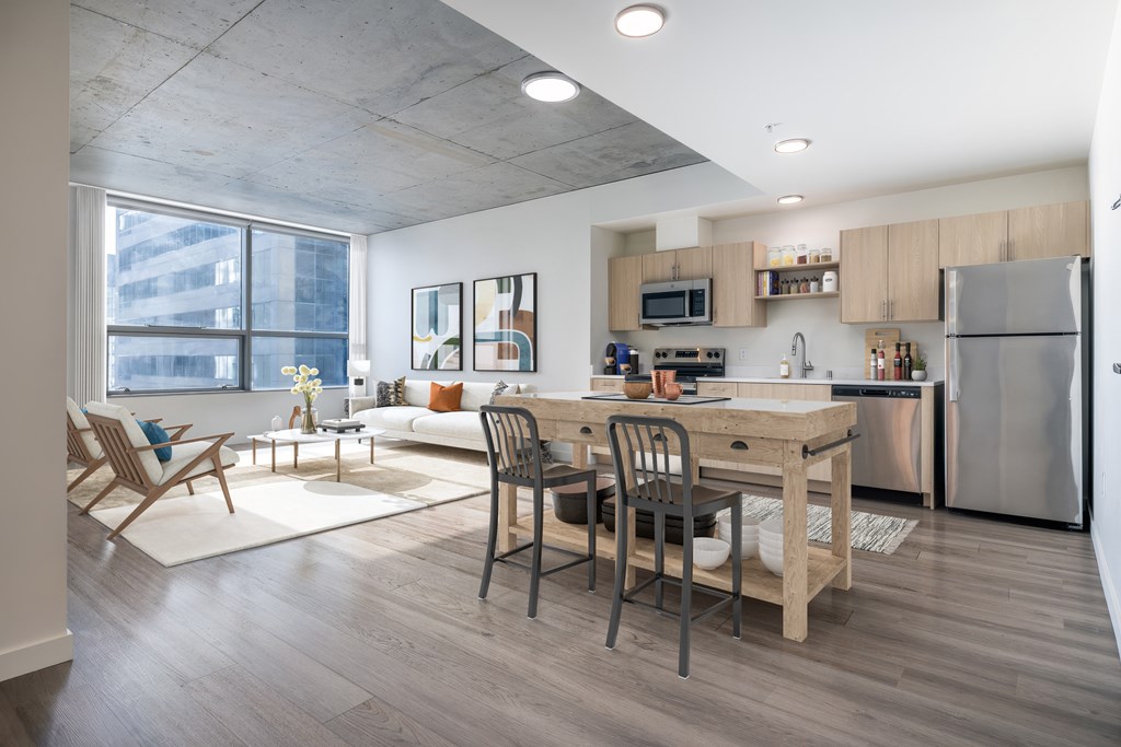 A modern kitchen with a dining table and chairs.