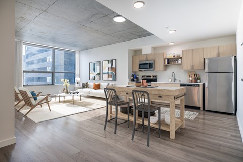 A modern kitchen with a dining table and chairs.
