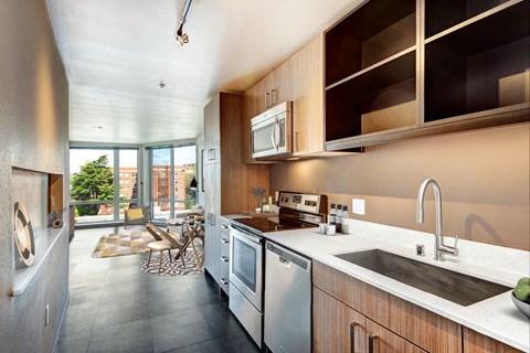 A modern kitchen with a dining table and chairs.