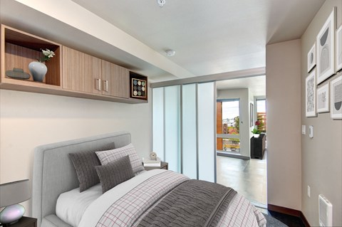 Bedroom with bed with storage above