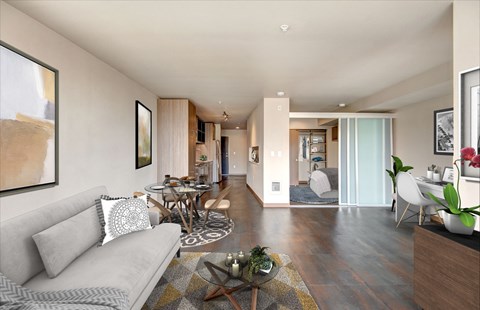 A modern living room with a grey sofa and a coffee table.