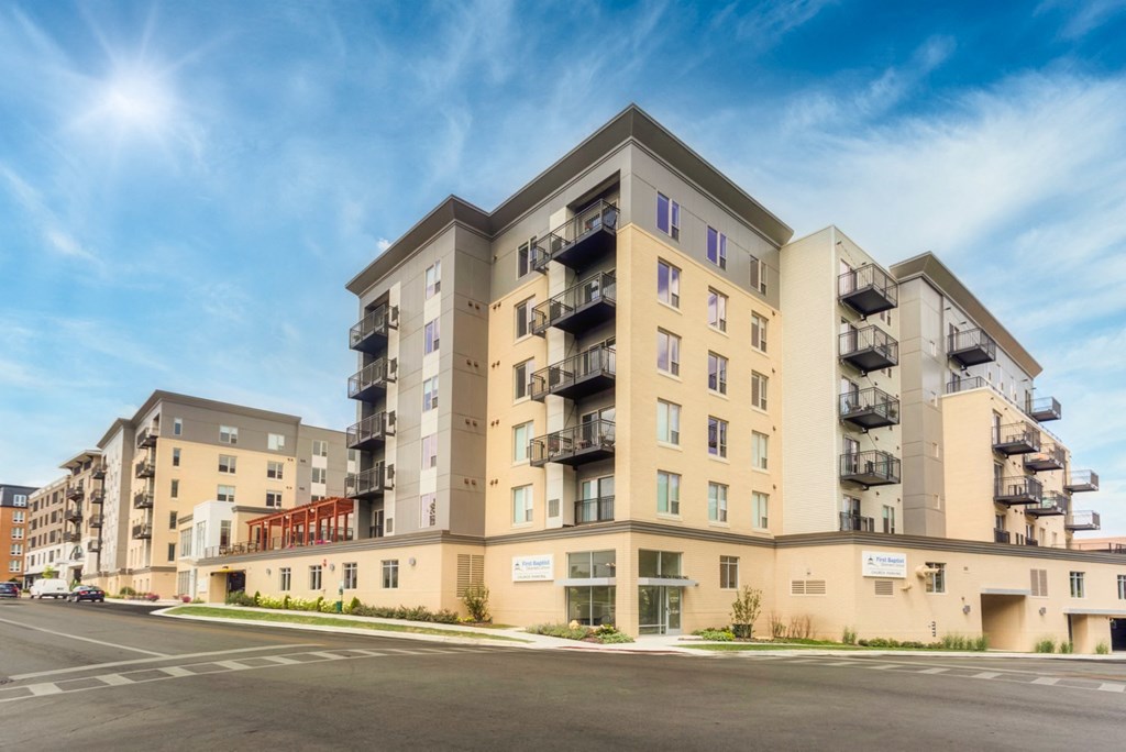 new apartment buildings on the corner of a street