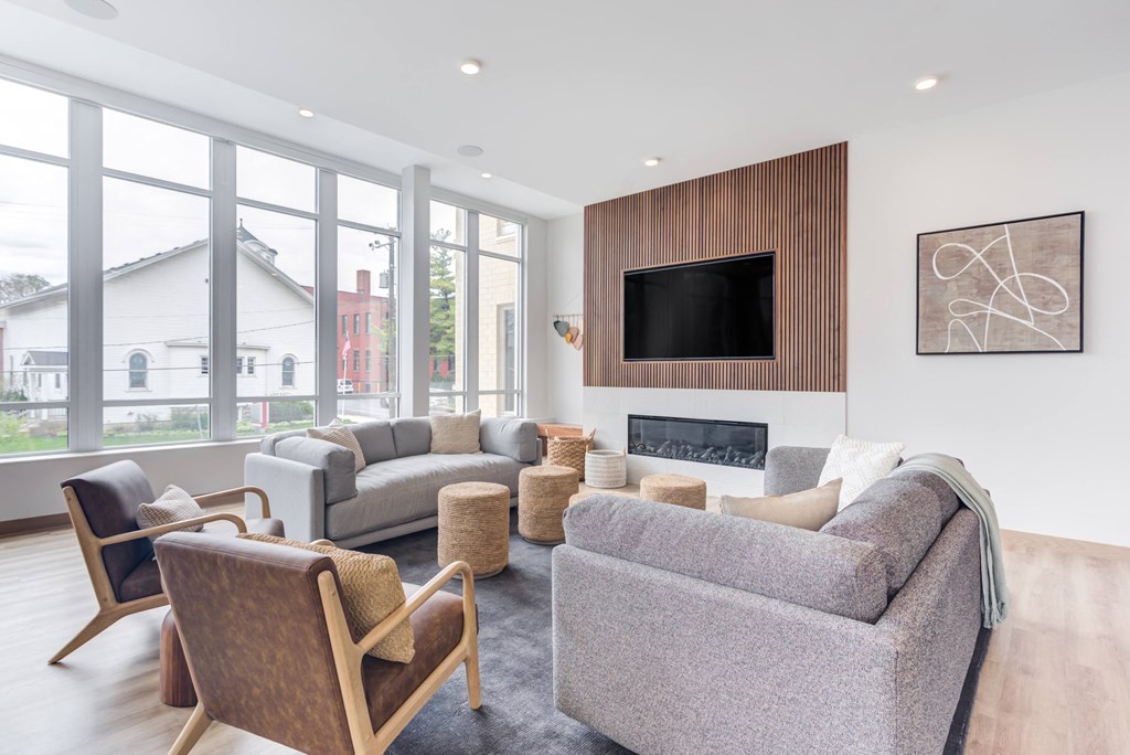a living room with couches and chairs and a fireplace