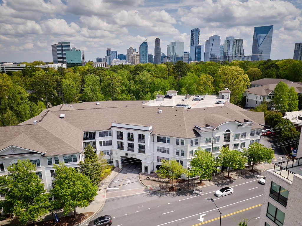 a large white building with a city skyline in the background