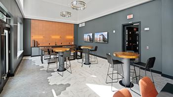 A modern dining area with a long table and chairs.