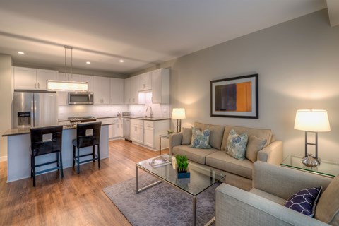 A modern kitchen with a dining table and a couch.