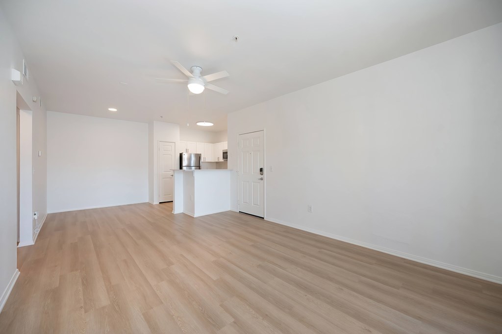A room with a wooden floor and a ceiling fan.