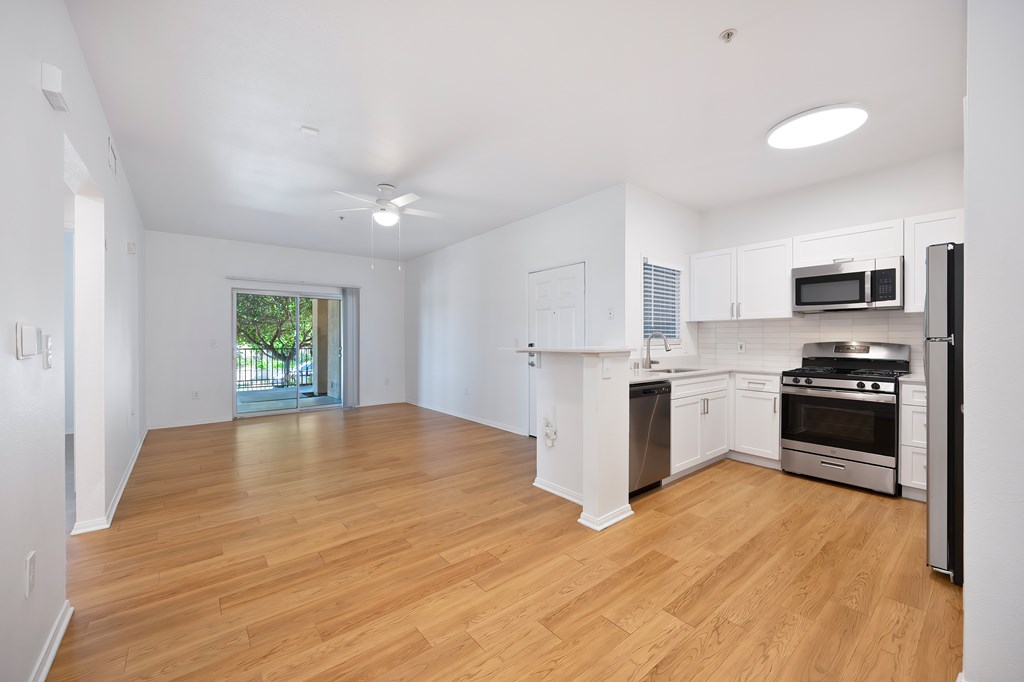 A kitchen with white cabinets and stainless steel appliances.