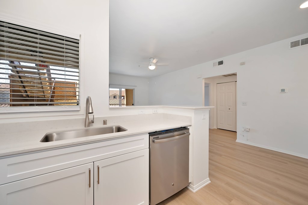 A kitchen with a sink and a dishwasher.