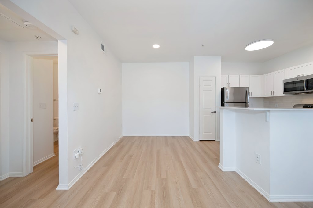 A kitchen area with a refrigerator, microwave, and oven.