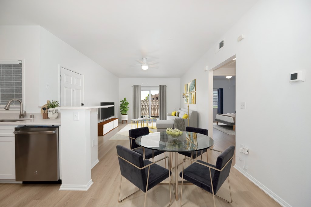 A modern kitchen with a dining table set for four.
