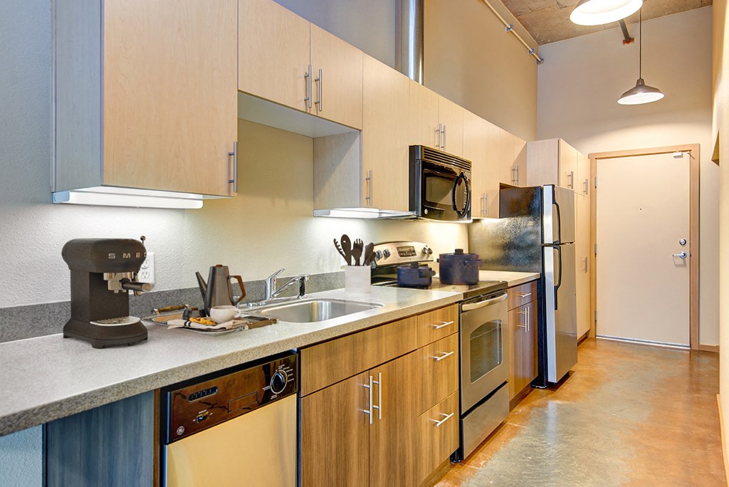 A kitchen with wooden cabinets and stainless steel appliances.