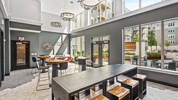 A modern dining area with a long table and chairs.