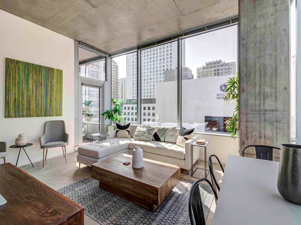 a living room with a couch and a table and a large window