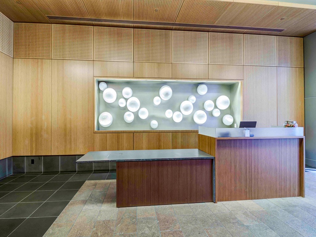 a reception area with a glass display of white circles