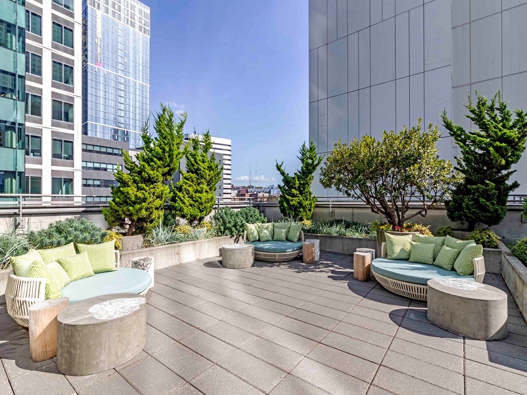a terrace with couches and chairs on a roof top