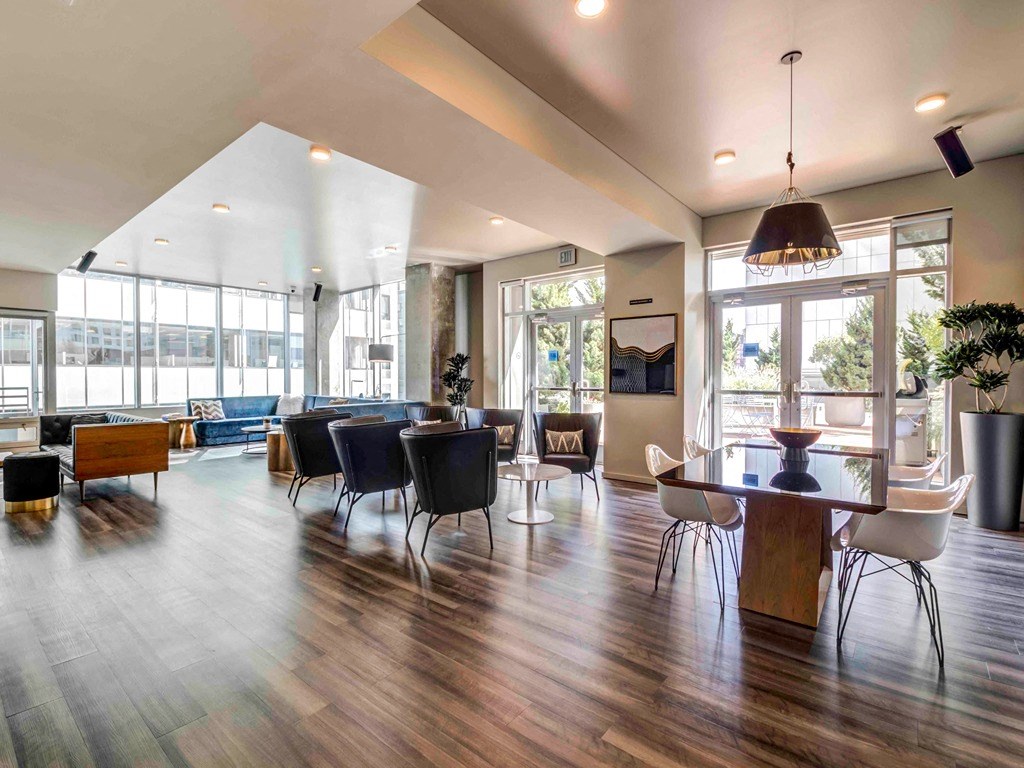 a large living room with a table and chairs
