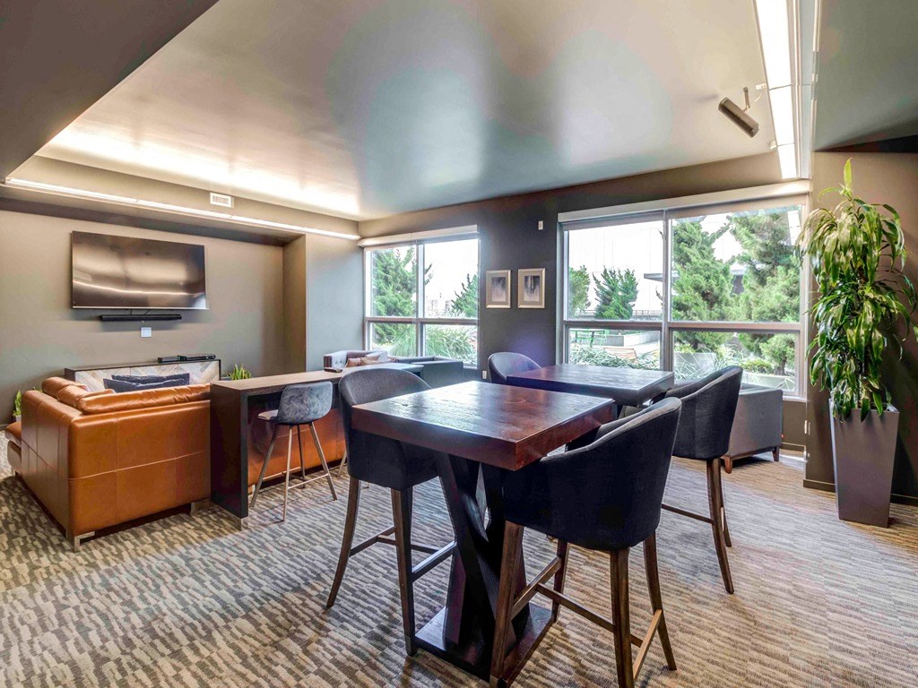a living room with a table and chairs and a tv