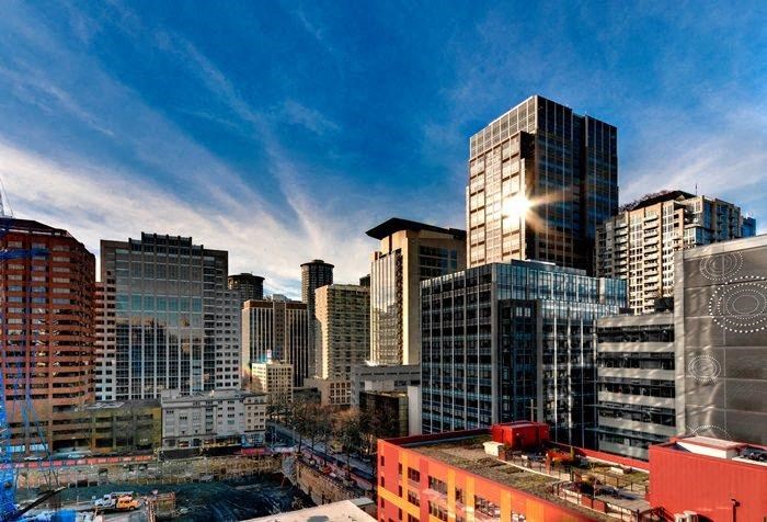 a city skyline with skyscrapers and a blue sky