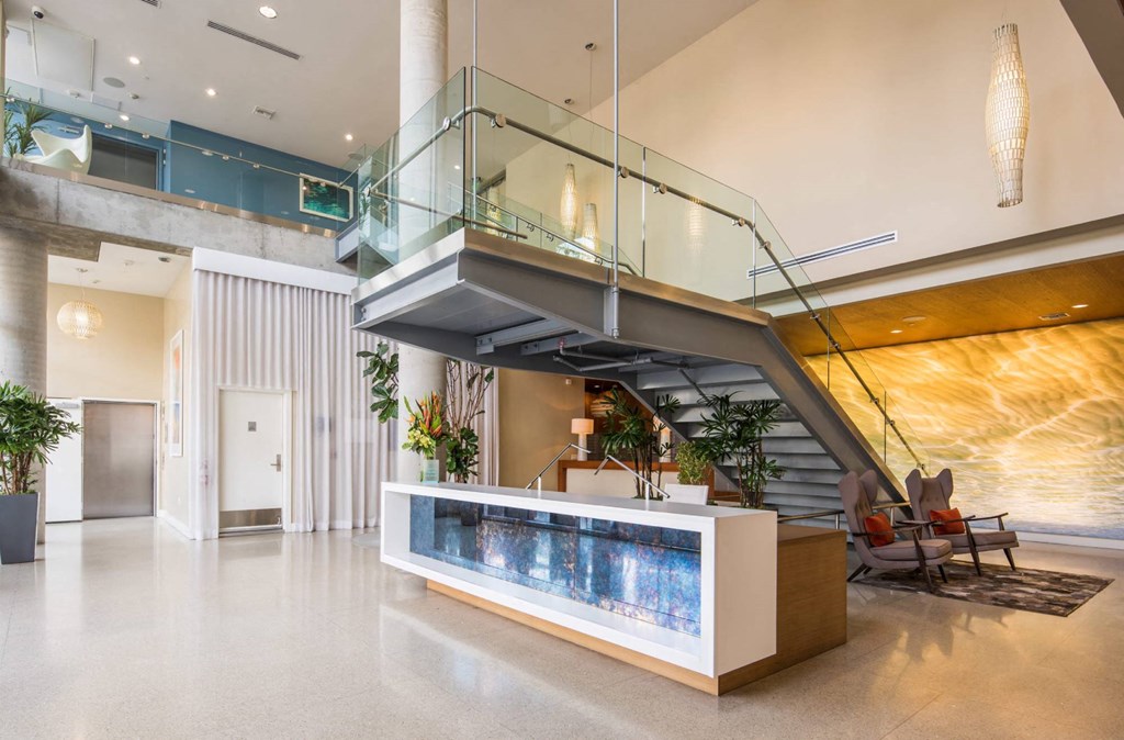 the lobby or reception area of a hotel with a staircase