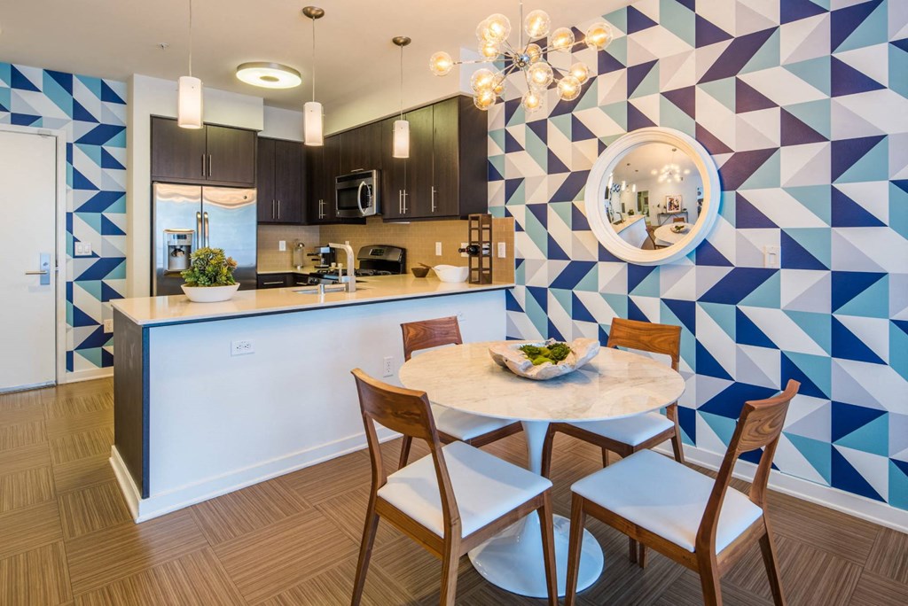 a kitchen and dining area with a blue and white wall