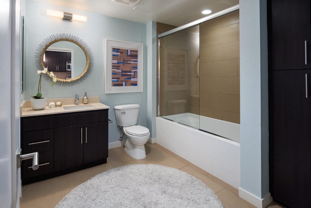 a bathroom with a toilet sink and a shower