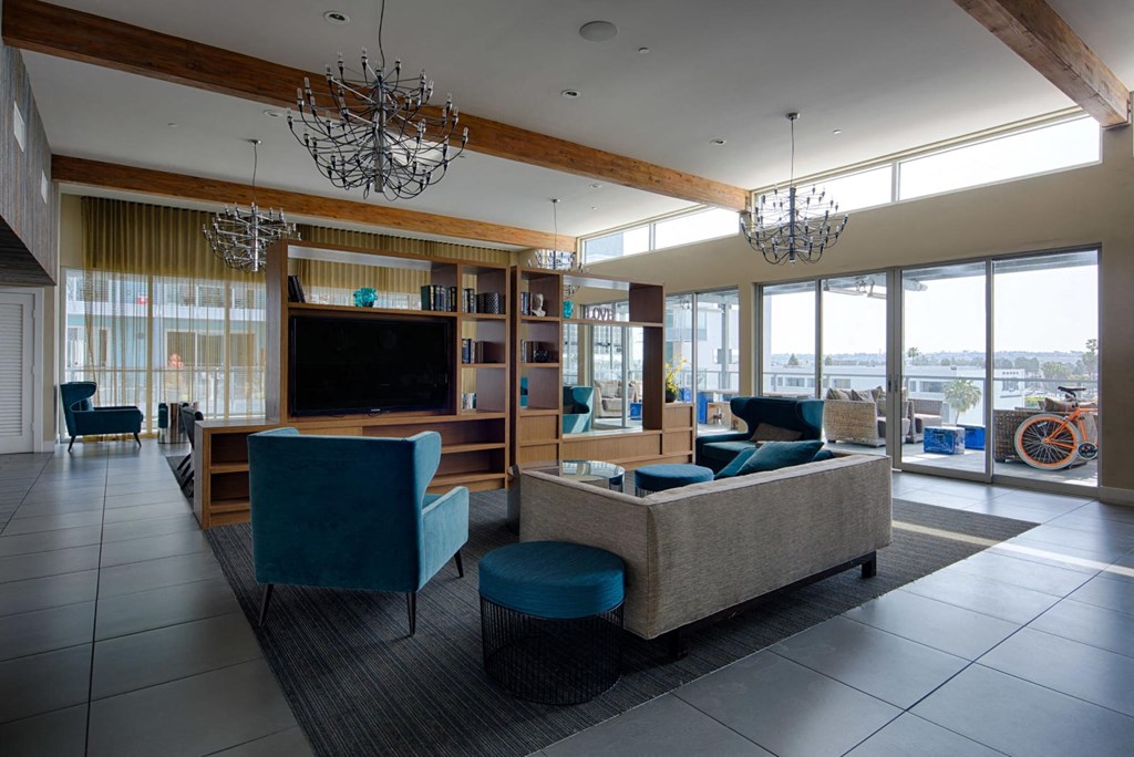 a living room with couches and chairs and a television