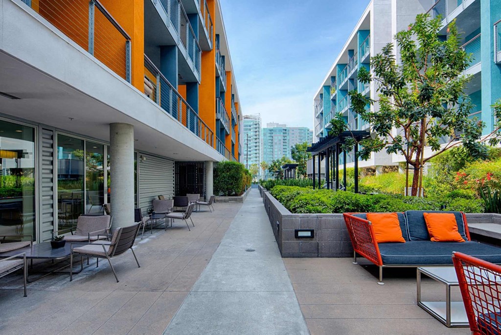 a rendering of a patio outside of a building with furniture and tables