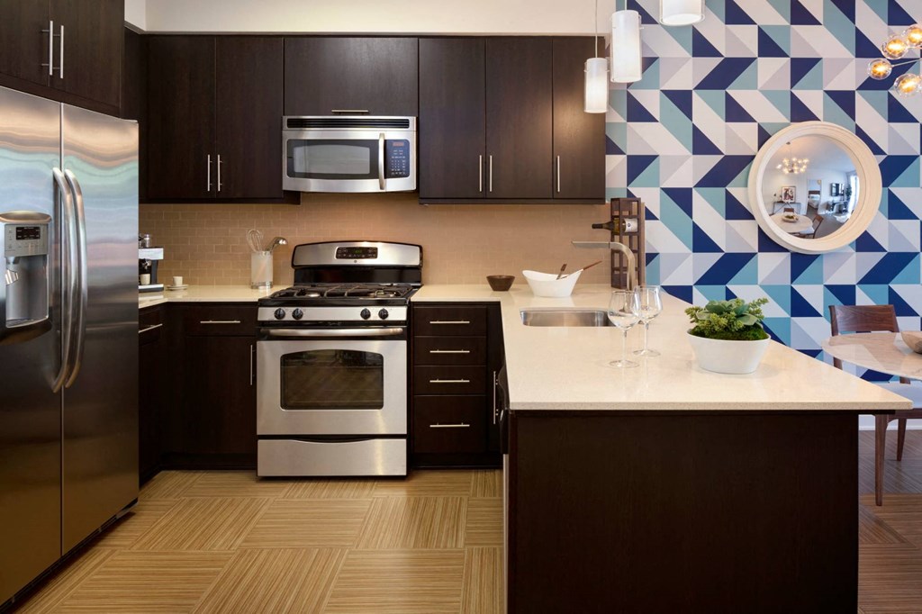 a kitchen with stainless steel appliances and a white counter top