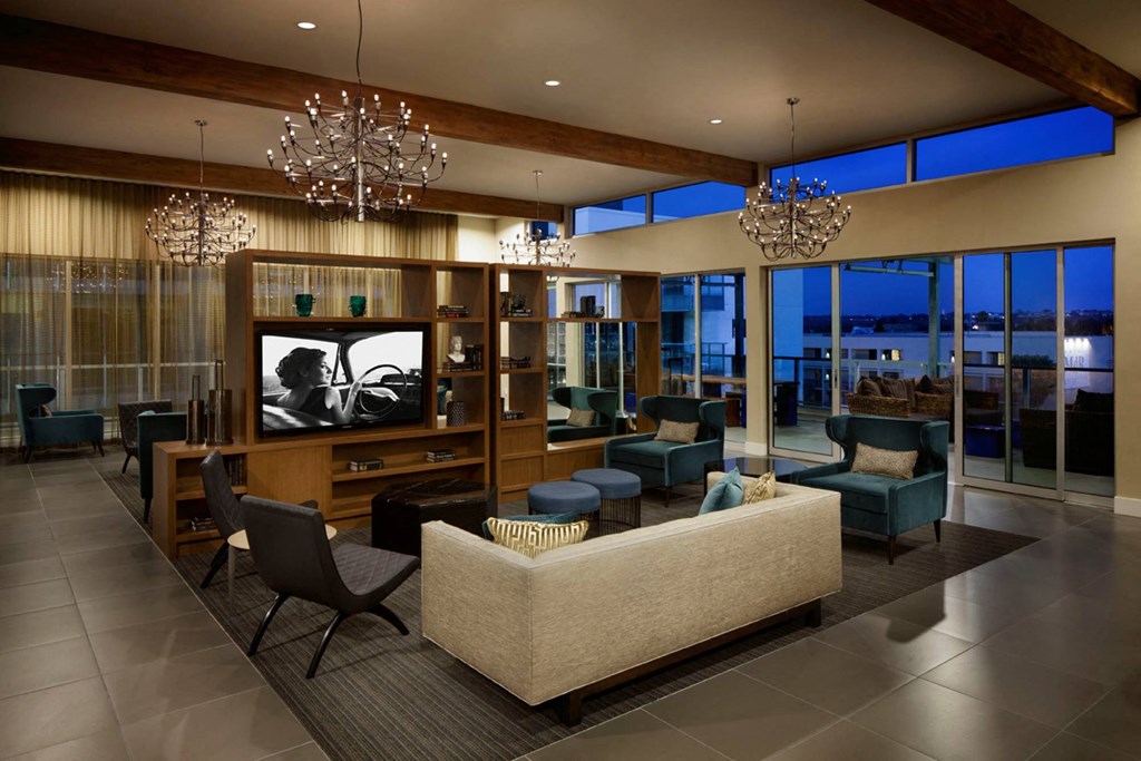 a living room with a couch and chairs and a television