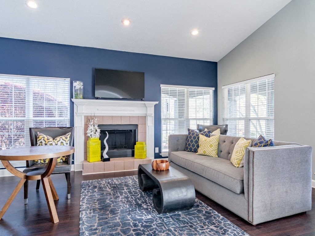 a living room with a couch and a table and a fireplace