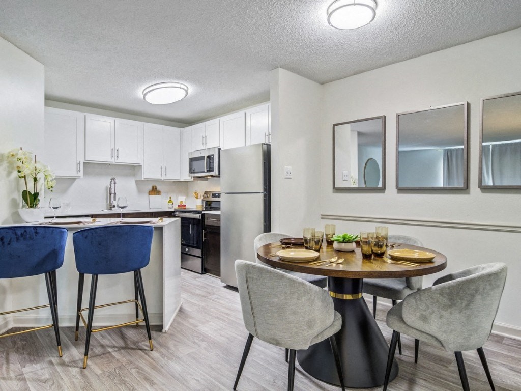 a kitchen and dining room with a table and chairs