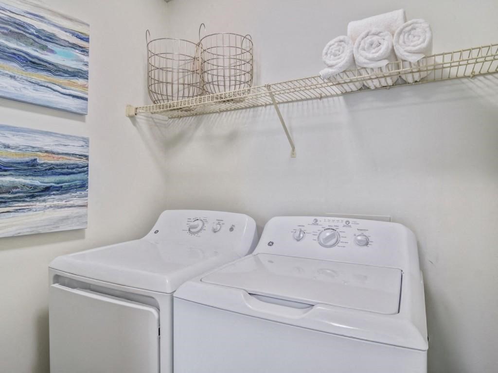 a white laundry room with a washer and dryer