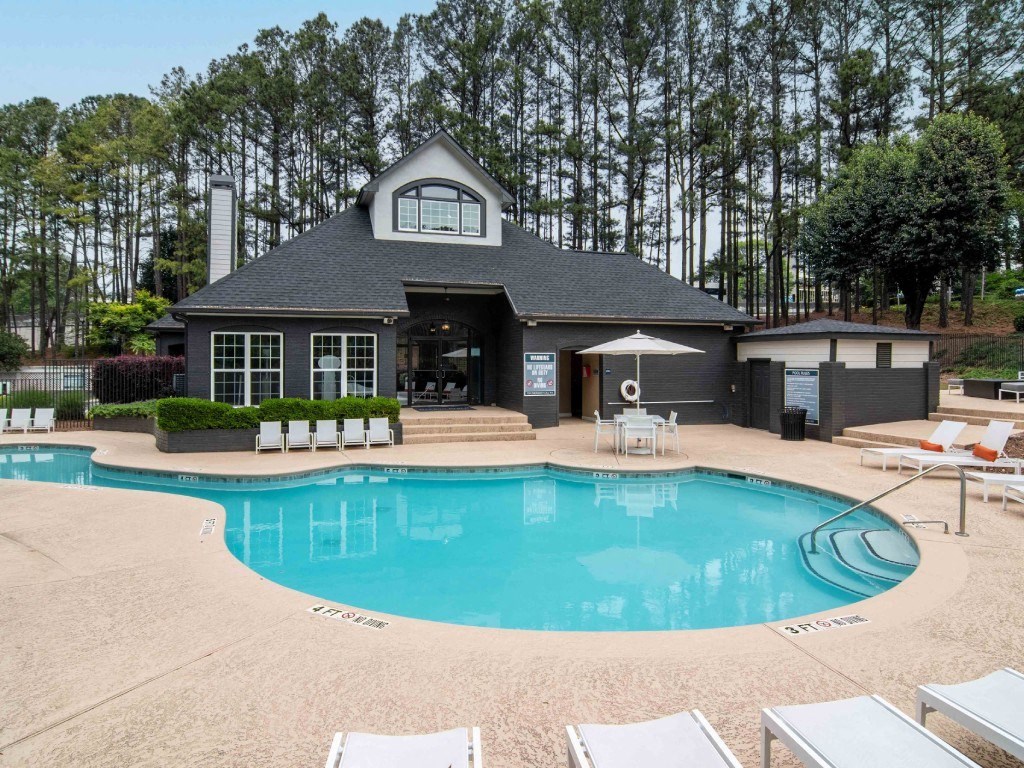 a swimming pool in front of a house