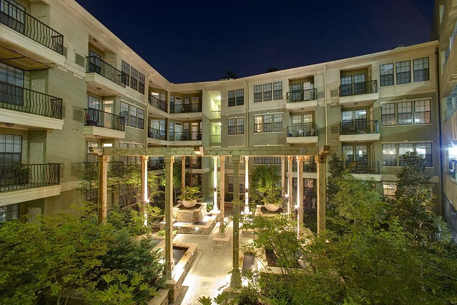 the courtyard of a large apartment building at night