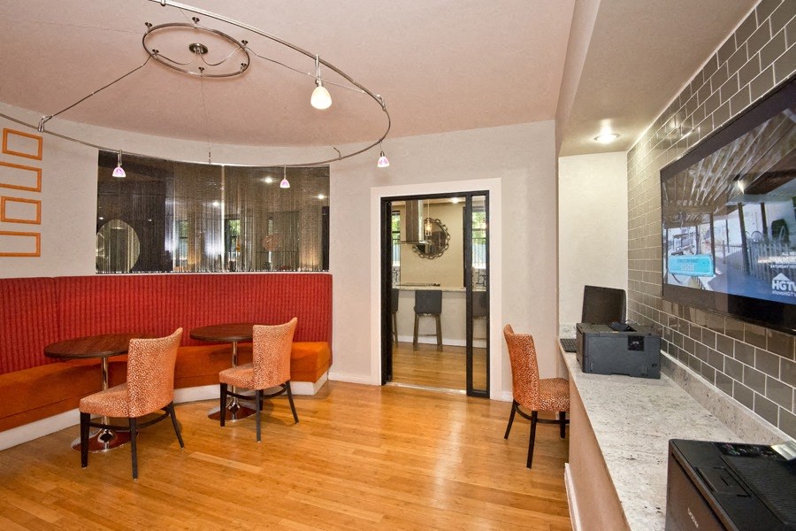 a lobby with a table and chairs and a television
