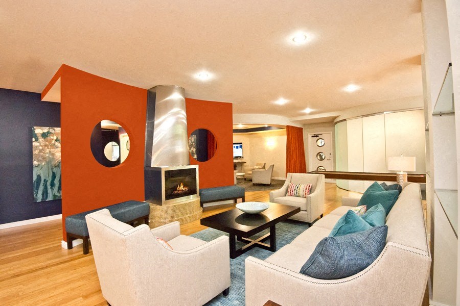 a living room with couches and chairs and a fireplace