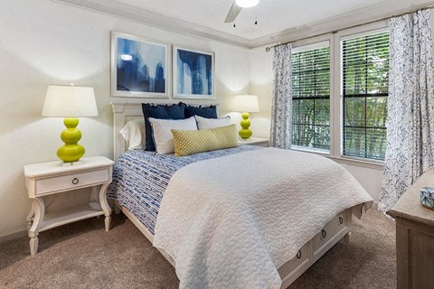 a bedroom with a bed and some windows