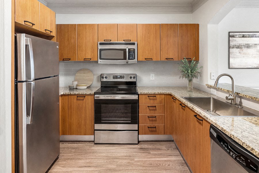 a kitchen with stainless steel appliances and wooden cabinets
