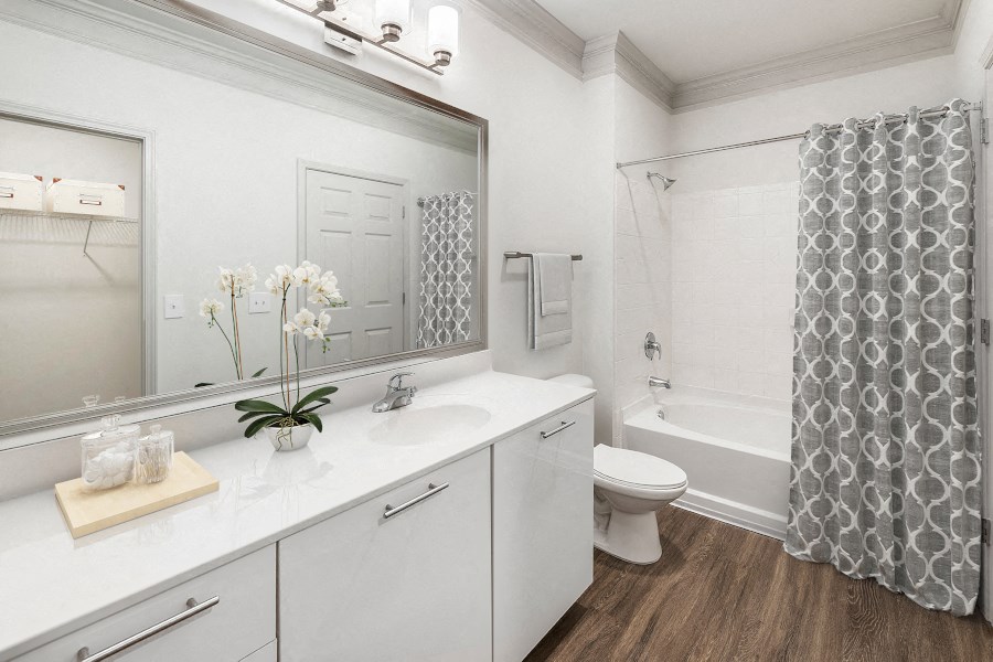 a white bathroom with a shower and a sink and a toilet