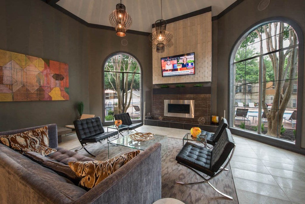 a living room with a couch and chairs and a television