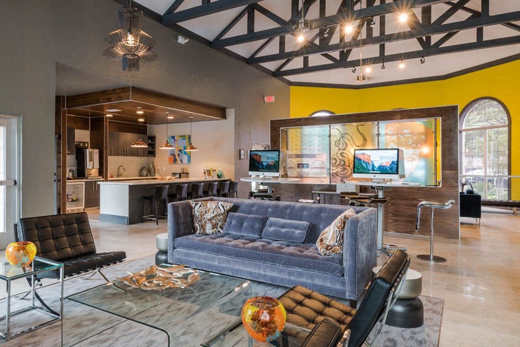 a living room with a blue couch and a kitchen