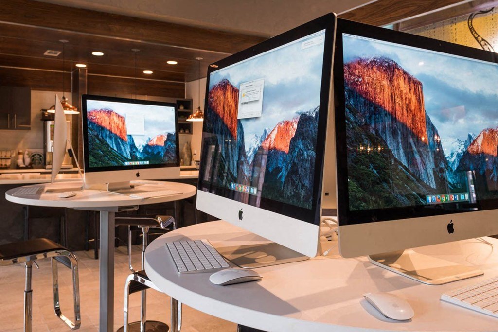 a room with two computer monitors on a table