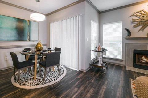 a dining room with a table and chairs next to a fireplace